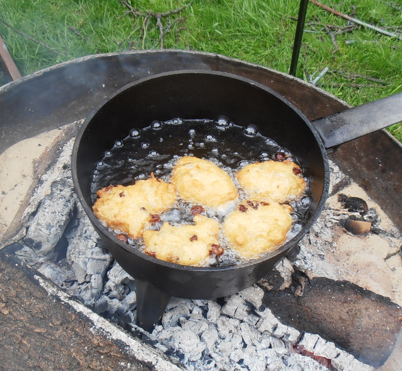 Cooking fritters on an open fire